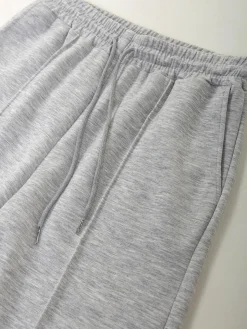 Calças fato treino com costura frontal