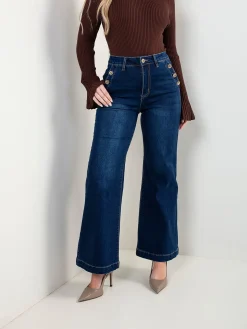 Calças ganga com botões dourados