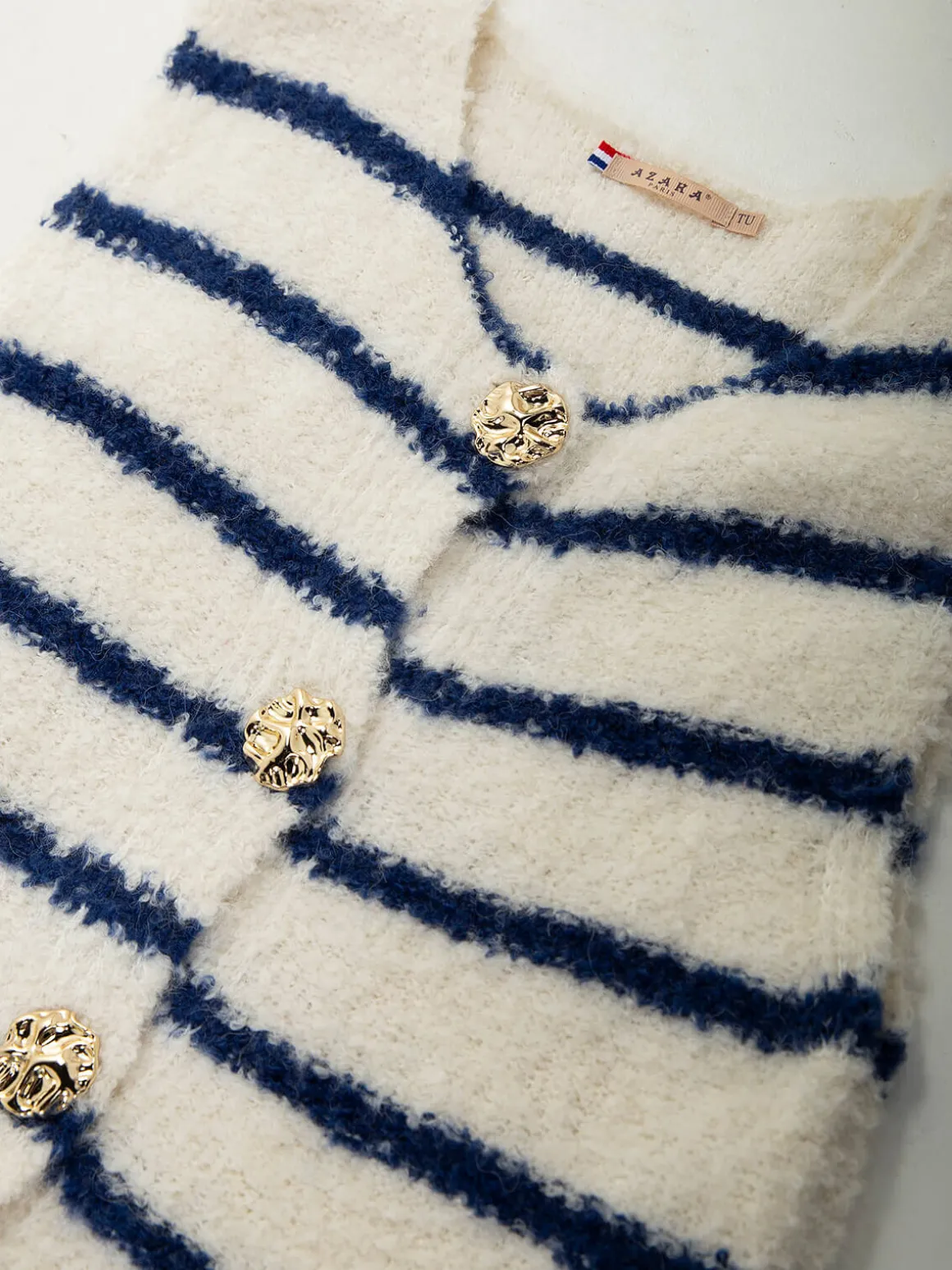 Colete malha às riscas com botões dourados